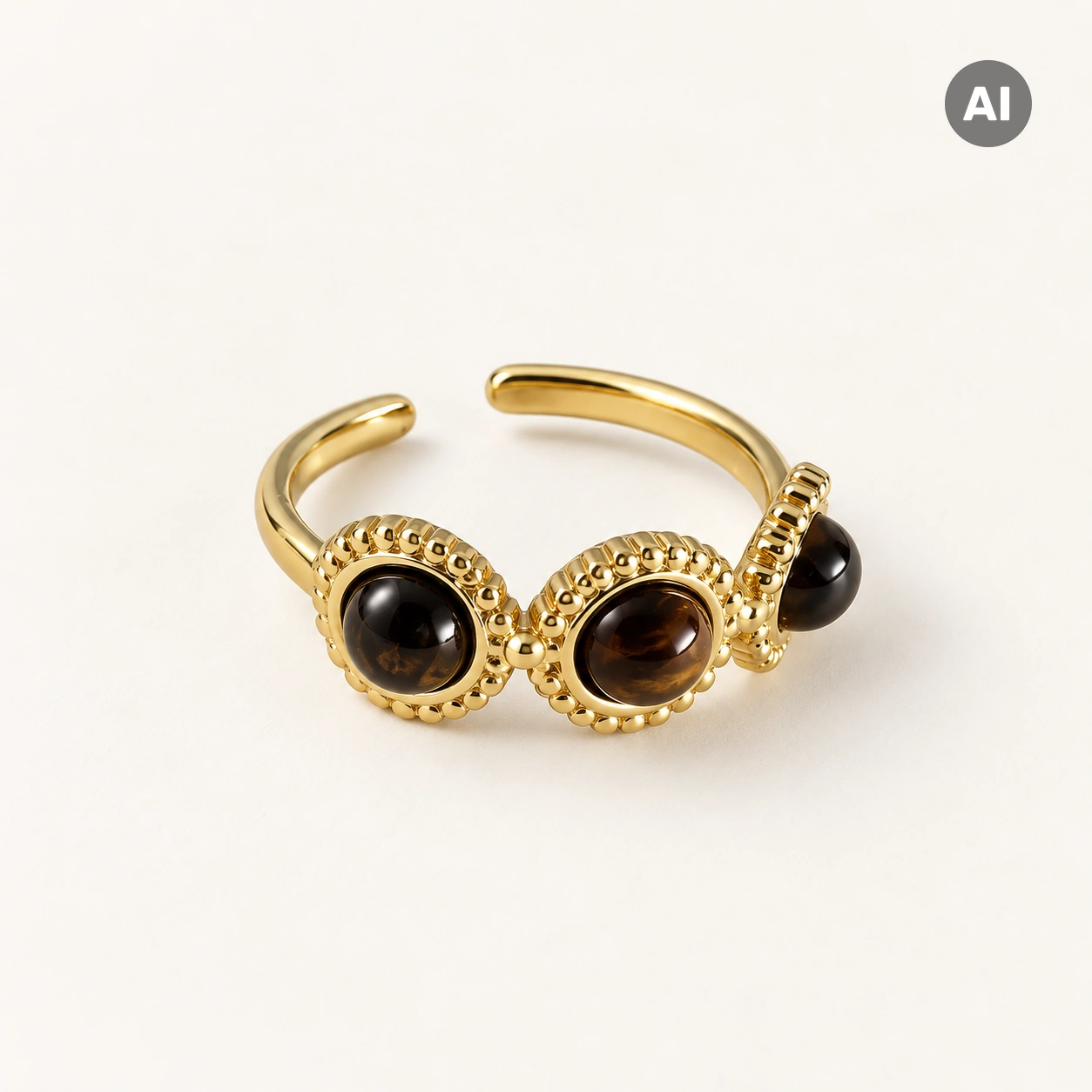 Ring mit drei braunen Steinen und Kugelrand, goldfarben